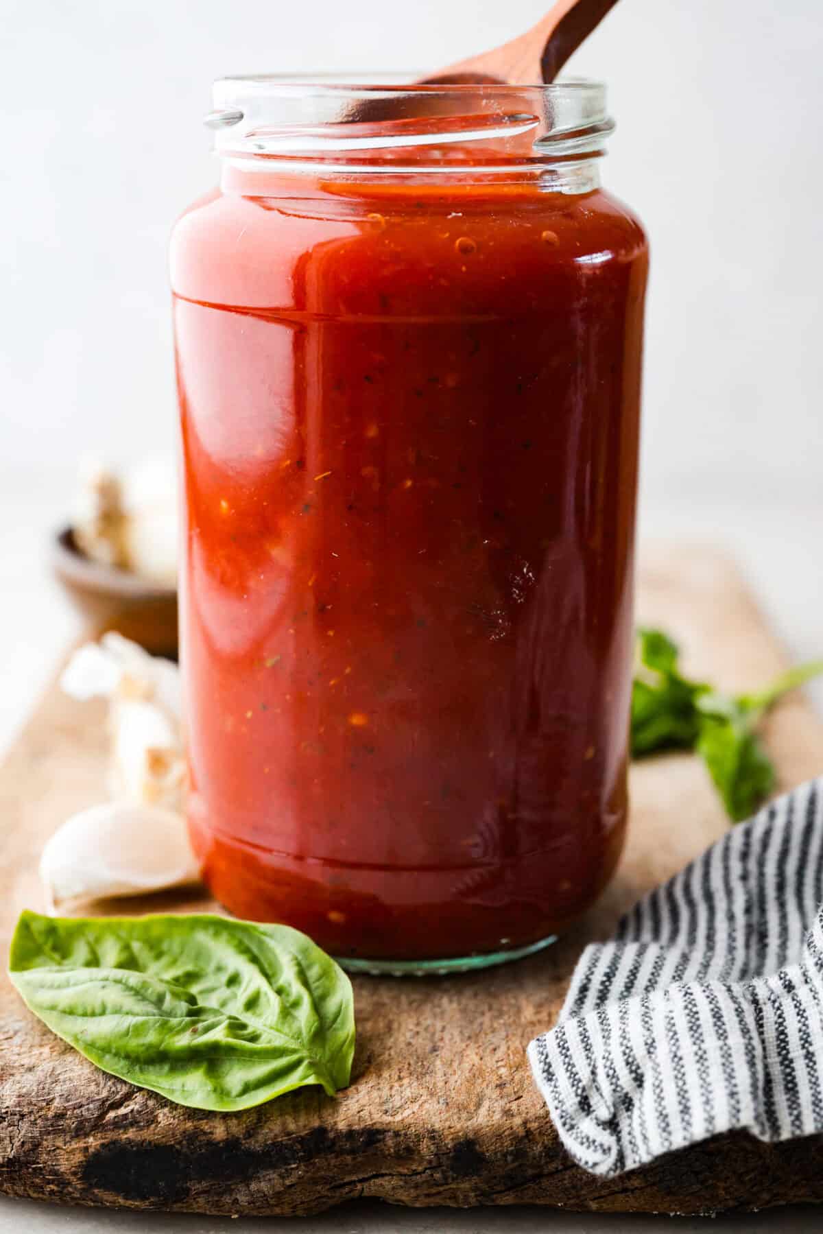 After re-testing this Homemade Marinara Sauce, I can confidently say it’s the BEST! You can make it in 15 minutes, but letting it simmer makes the flavors even better! A glass jar filled with homemade marinara sauce.